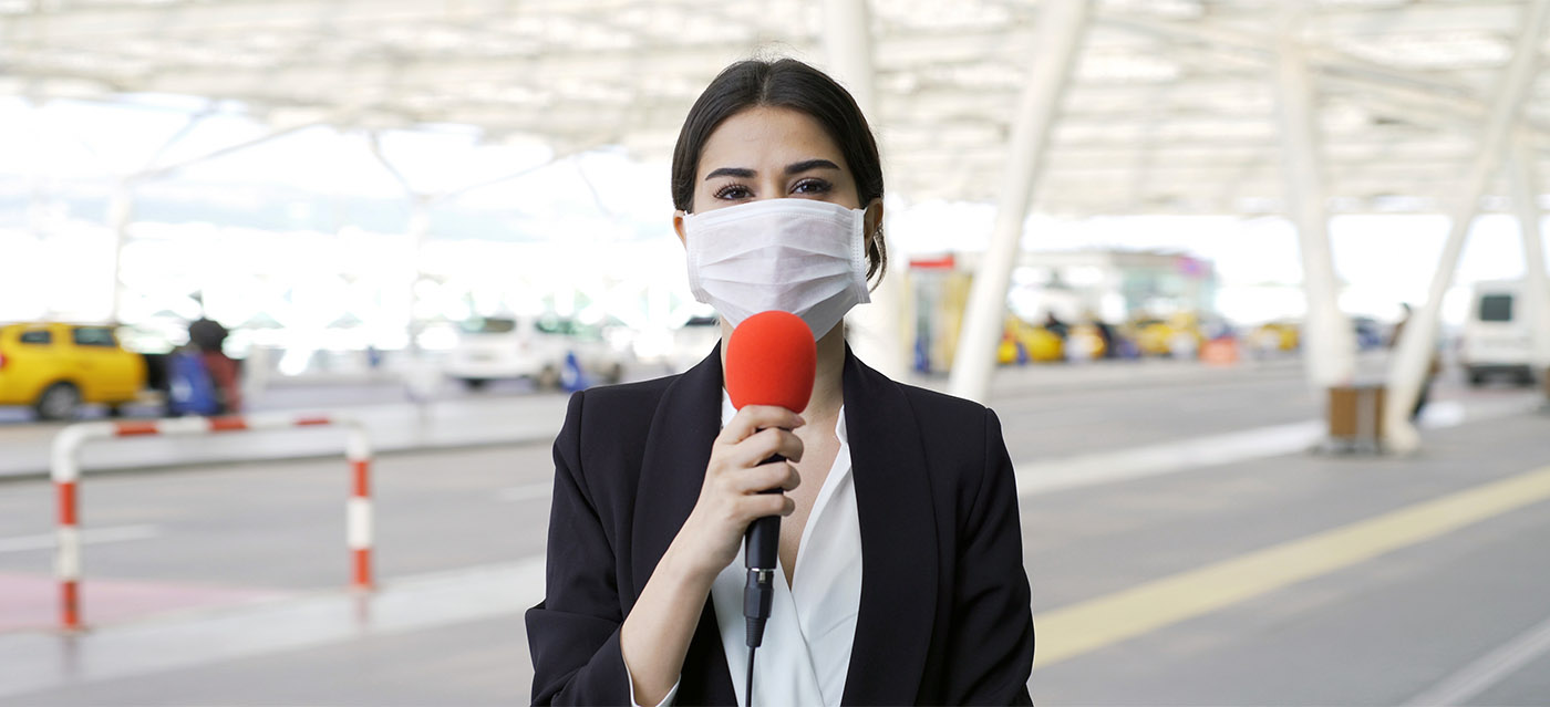 TV reporter wearing a mask - RH Strategic