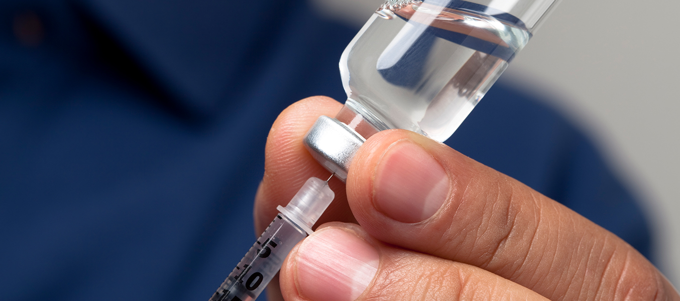 Communications lessons from the Eli Lilly story - hand holding an insulin syringe