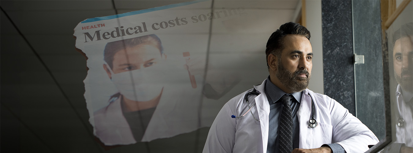 Concerned male doctor thinking about negative news cycle