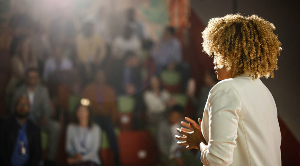 Female thought leader speaking at an event