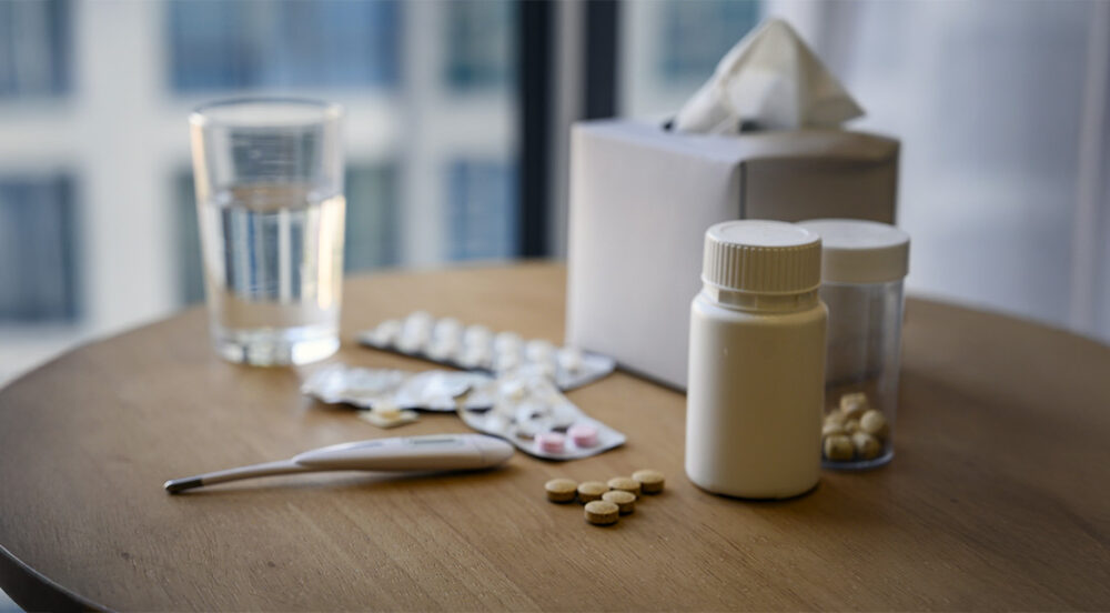 Tissue, medicine, glass of water on the table