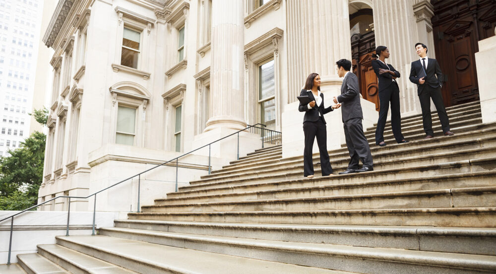Policy professionals in discussion on steps of the US Capitol.