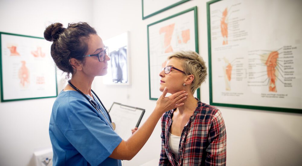 Professional medical doctor examining patient in her office.